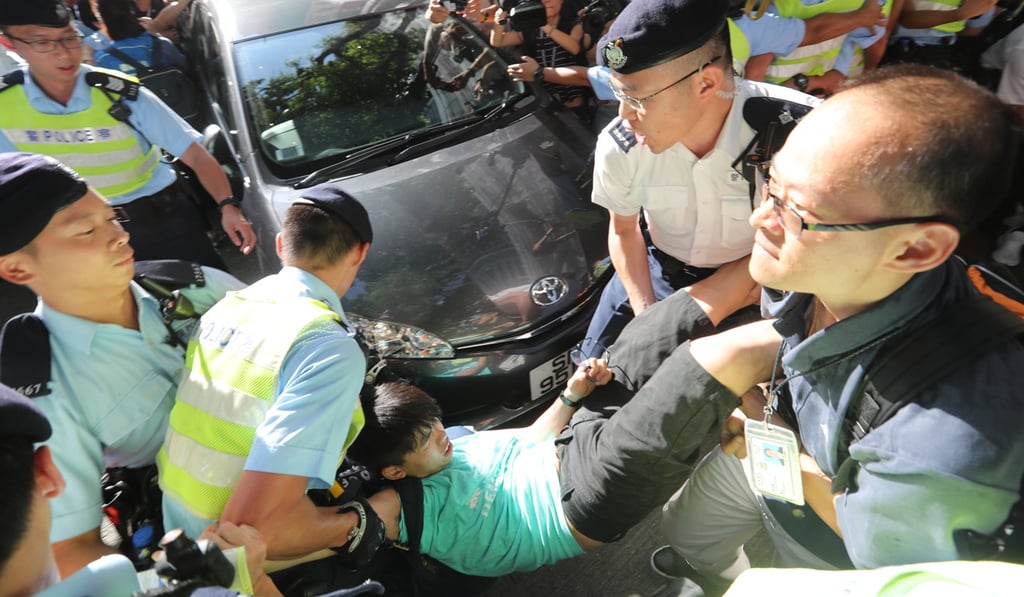 Activist Joshua Wong is carried away by police officers. Photo: Edward Wong