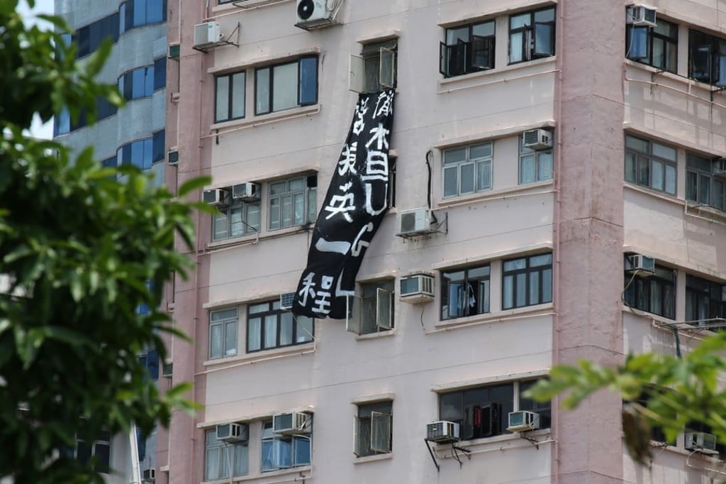 A banner slamming Chief Executive Leung Chun-ying over his UGL saga is hung from a building. Photo: Felix Wong