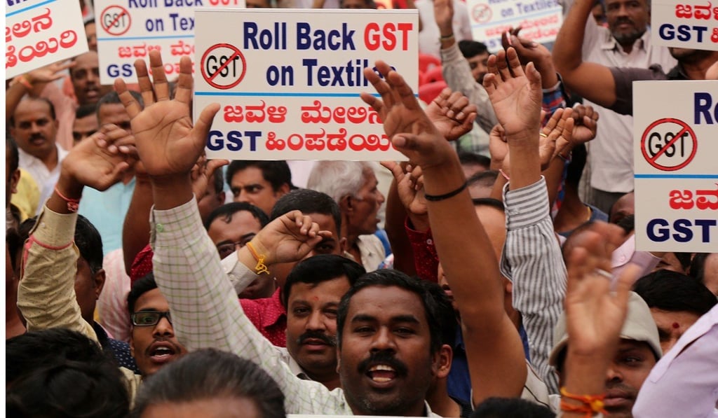 A protest against the Goods and Services Tax in Bangalore, India. Photo: EPA A protest against the Goods and Services Tax in Bangalore, India. Photo: EPA