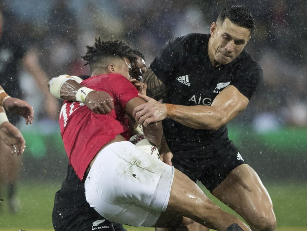 Sonny Bill Williams (right) tackles Lions winger Anthony Watson. Photo: AP