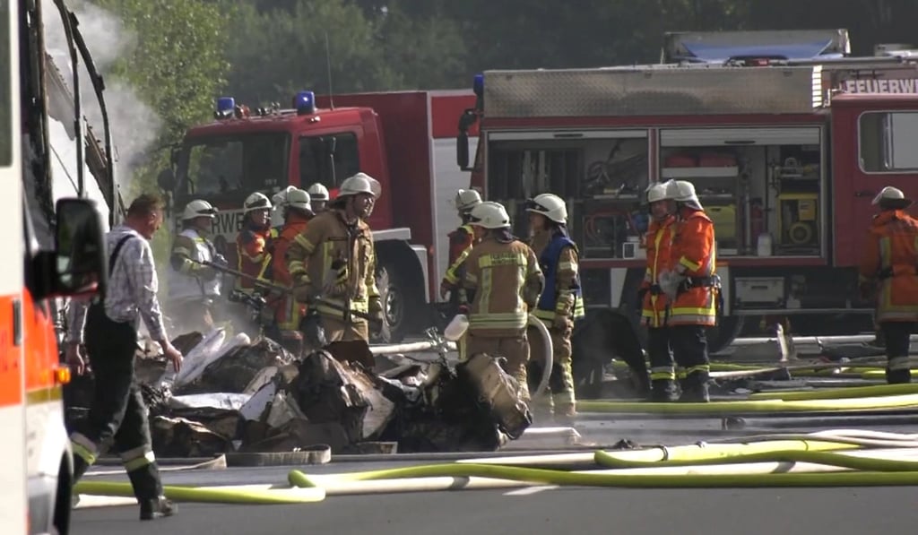 Firefighters at the site of the coach crash. Photo: Reuters