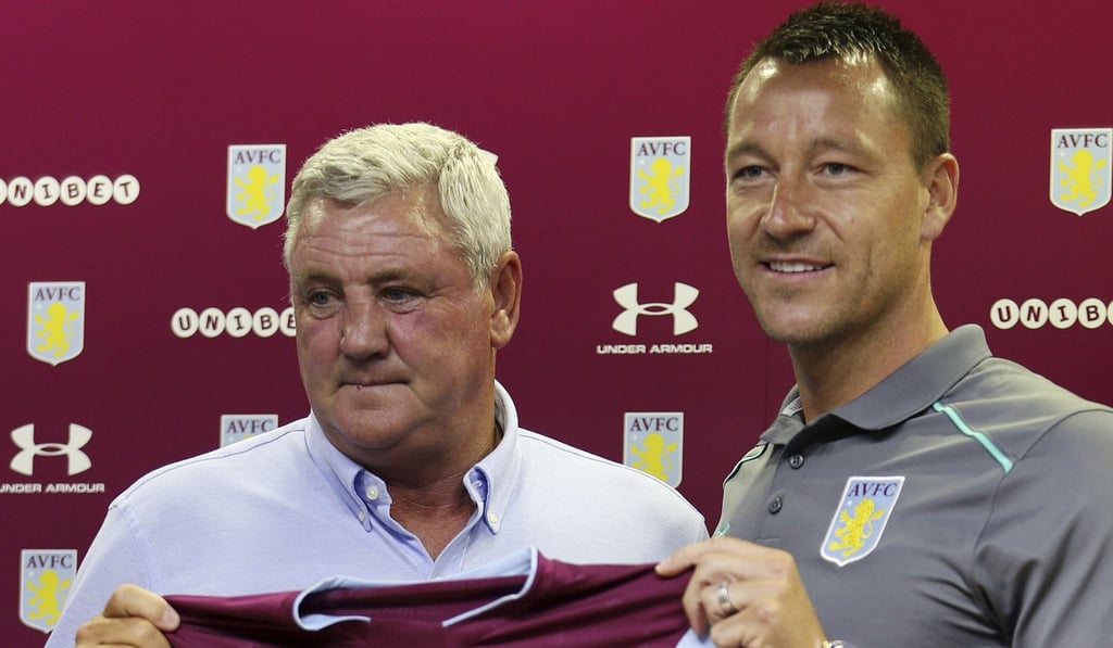 John Terry with Aston Villa manger Steve Bruce on Monday. Photo: AP