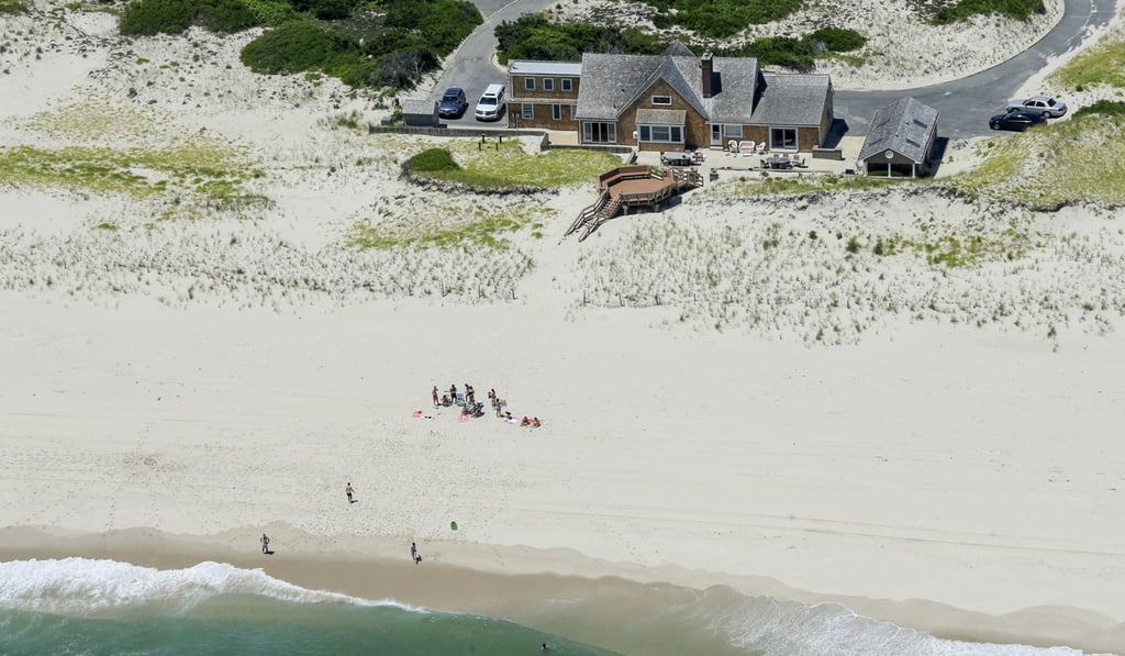 In this July 2 photo, New Jersey Governor Chris Christie uses the beach with his family and friends at the governor's summer house at Island Beach State Park in New Jersey. The beach is otherwise empty because of a government shutdown that critics blame on Christie. Photo: AP