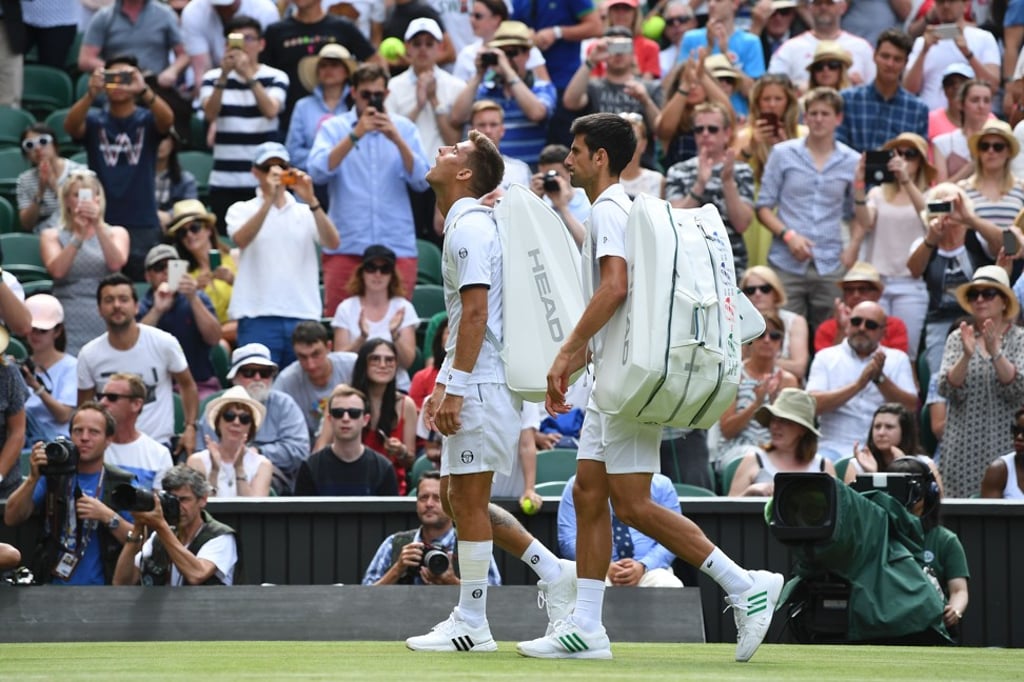 Slovakia's Martin Klizan (left) and Novak Djokovic walk off Centre Court. Photo: AFP Slovakia's Martin Klizan (left) and Novak Djokovic walk off Centre Court. Photo: AFP