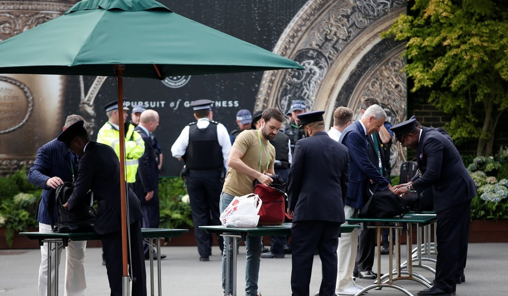 Security staff check visitors before the start of play at Wimbledon, with heightened security the order of the day. Photo: Reuters