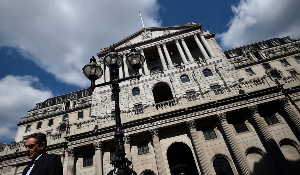 A man stands outside the Bank of England in the City of London. Photo: Reuters