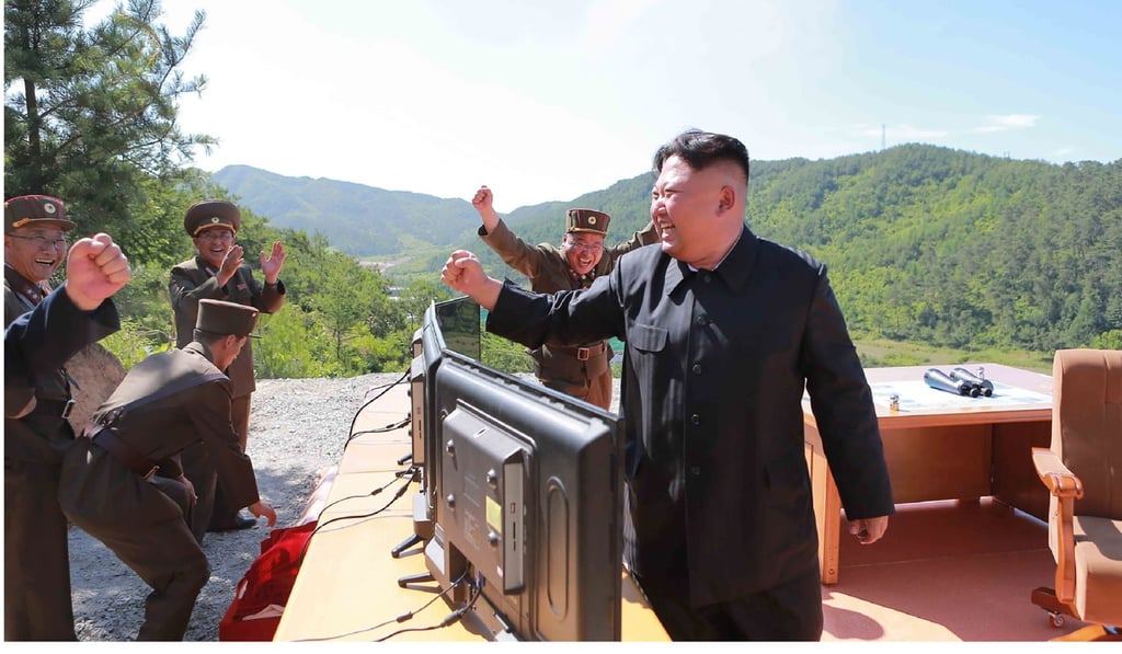 This picture taken and released on July 4 by North Korea's official Korean Central News Agency (KCNA) shows North Korean leader Kim Jong-Un celebrating the launch of a Hwasong-14 ICBM at an undisclosed location. Photo: AFP
