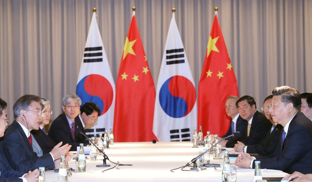 South Korean President Moon Jae-in (left) and Chinese President Xi Jinping (right) in Berlin on Thursday. Photo: EPA