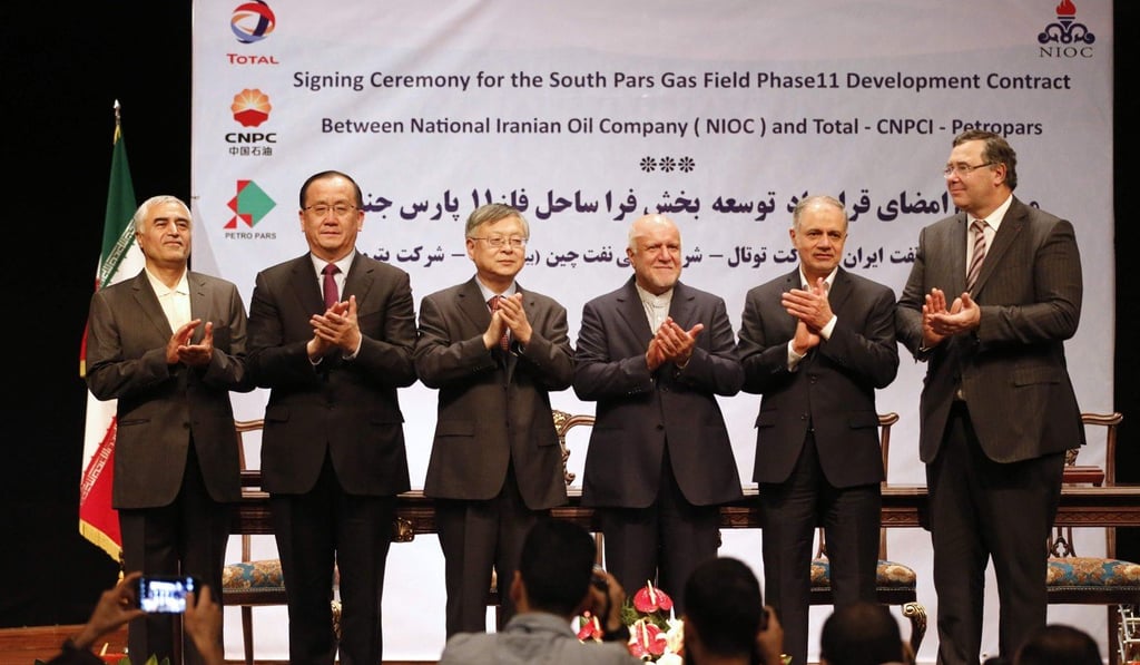 Executives and officials from the National Iranian Oil Company, Total and Petropras Group stand on stage after signing an offshore gas field agreement in Tehran. Photo: AFP Executives and officials from the National Iranian Oil Company, Total and Petropras Group stand on stage after signing an offshore gas field agreement in Tehran. Photo: AFP