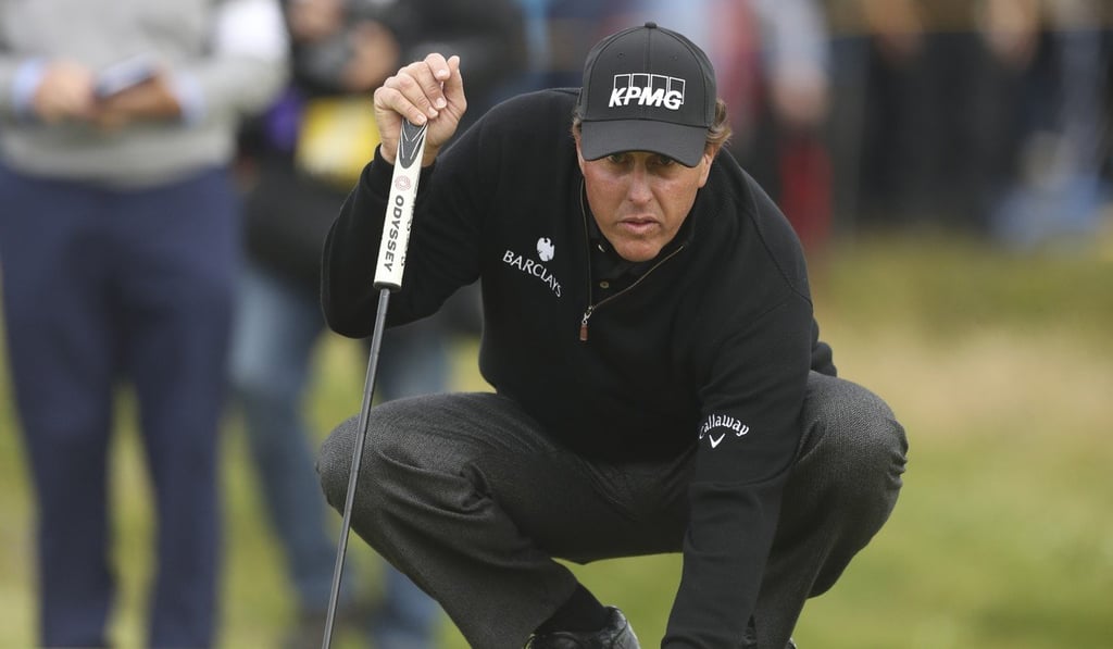 Phil Mickelson of the United States places his ball prior to putting on the 13th green during the final round of the British Open Golf Championship at the Royal Troon Golf Club in Troon, Scotland, last year. Photo: AP