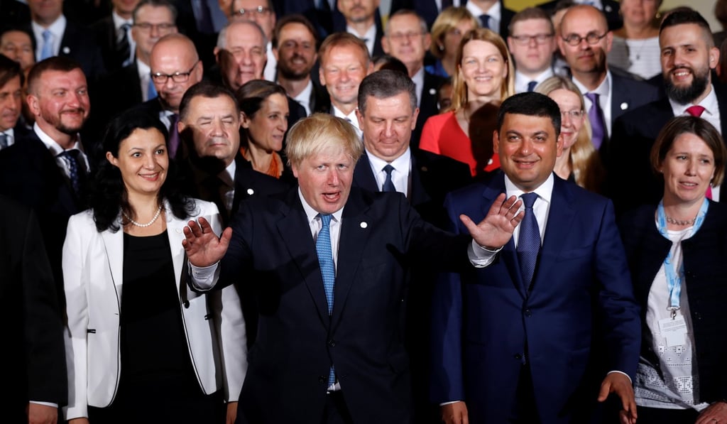 Britain's Foreign Secretary Boris Johnson poses for a photo at Lancaster House in London with fellow attendees of the Ukraine Reform Conference on Thursday. Photo: Reuters