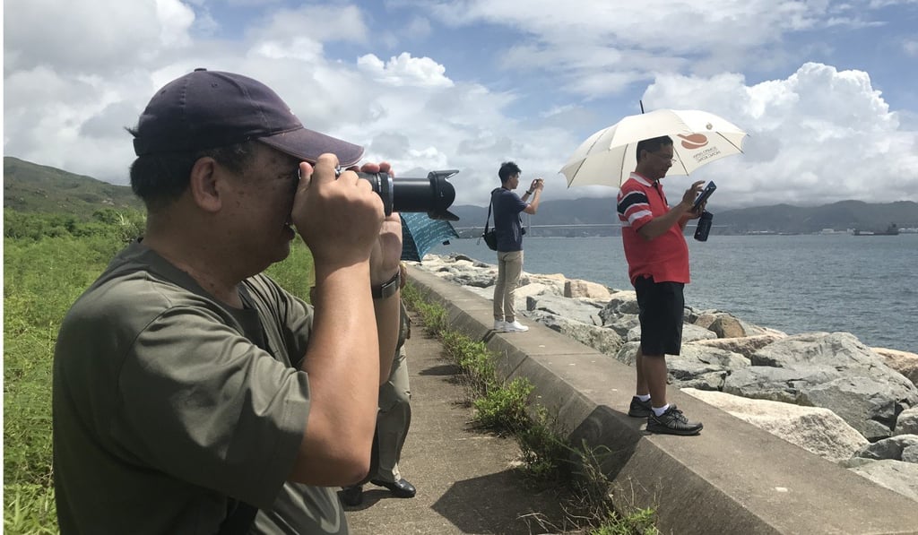 Yu Zhaoping, 63, a new Hong Kong resident from China’s Fujian Province, was excited to see the Liaoning from Disneyland Resort Pier. Photo: Tracy Zhang