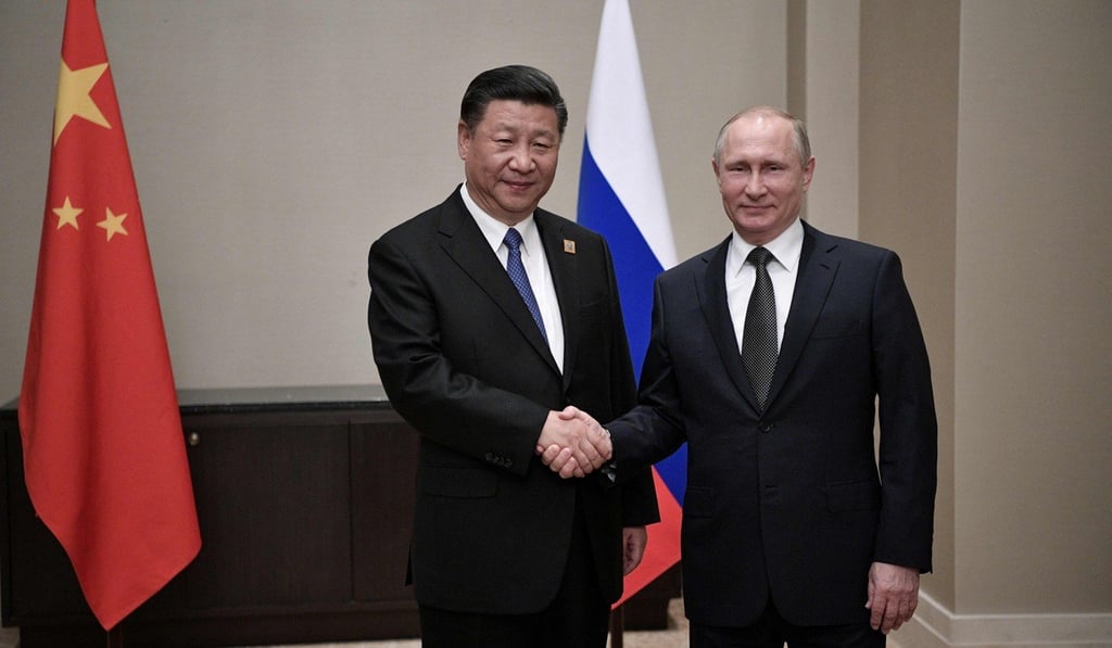 Chinese President Xi Jinping shakes hands with Russian President Vladimir Putin during their meeting in Astana. The two countries are increasing their economic cooperation along the border. Photo: AFP