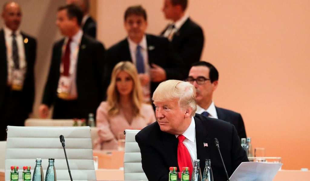 US President Donald Trump sits in front of his delegation with daughter Ivanka Trump, background centre, as he attends a working session at the G20 summit. Photo: Reuters