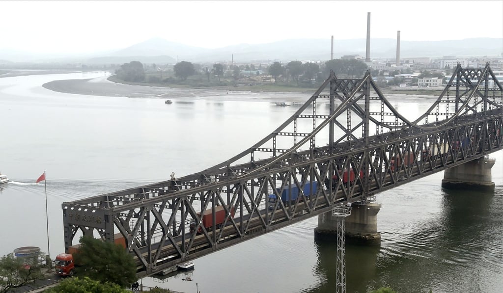 Trucks from North Korea cross a bridge on the border with China in Dandong. Photo: Kyodo