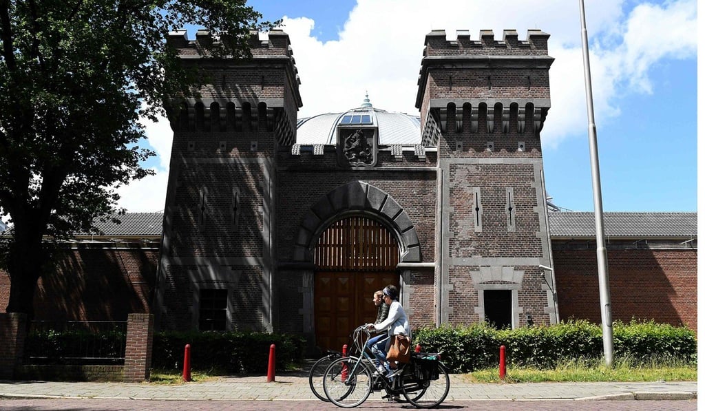 People cycle past Boschpoort Prison in Breda, which is being transformed into offices and an entertainment venue. Photo: AFP People cycle past Boschpoort Prison in Breda, which is being transformed into offices and an entertainment venue. Photo: AFP