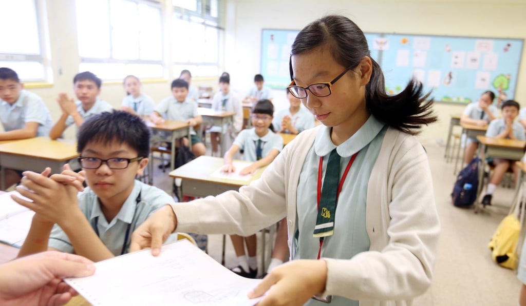 Lau Ka-ki (right) finds out which secondary school she has been allocated. Photo: Xiaomei Chen