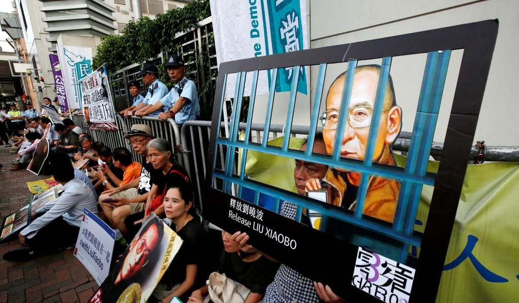 Pro-democracy activists stage a protest demanding the release of Nobel laureate Liu Xiaobo outside the central government’s liaison office in Hong Kong on Monday. Photo: Reuters