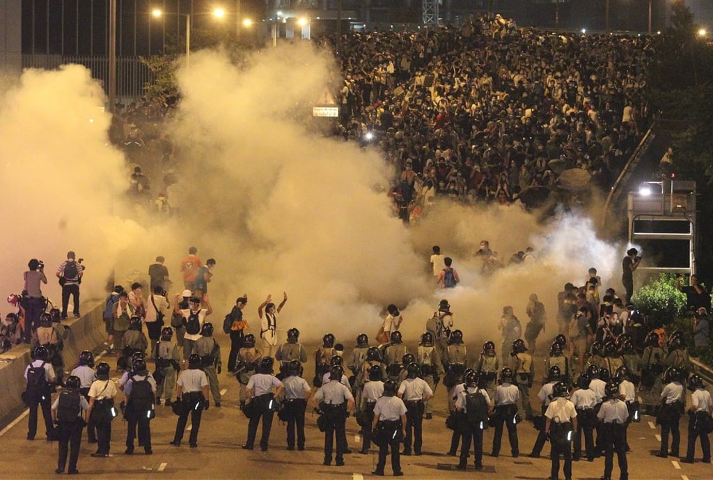 Police fire tear gas at protesters in Central after “Occupy Central” was launched on September 28, 2014. Picture: Dickson Lee