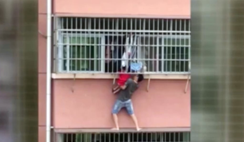 With little to hang on to, the neighbour lifted the boy through the window grille. Photo: Handout