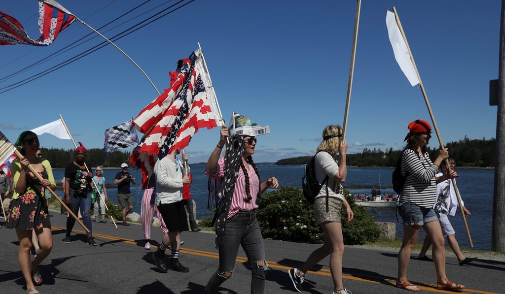 People march during a parade marking Independence Day in Deer Isle, Maine. Places like Maine are one of the areas where a Microsoft broadband initiative would expand access to internet services. Photo: Reuters