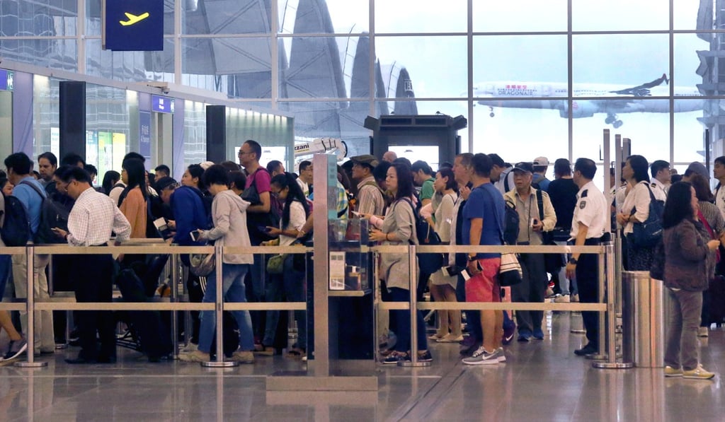 Tourists crowd through an exit gate at Hong Kong International Airport. Photo: K.Y. Cheng