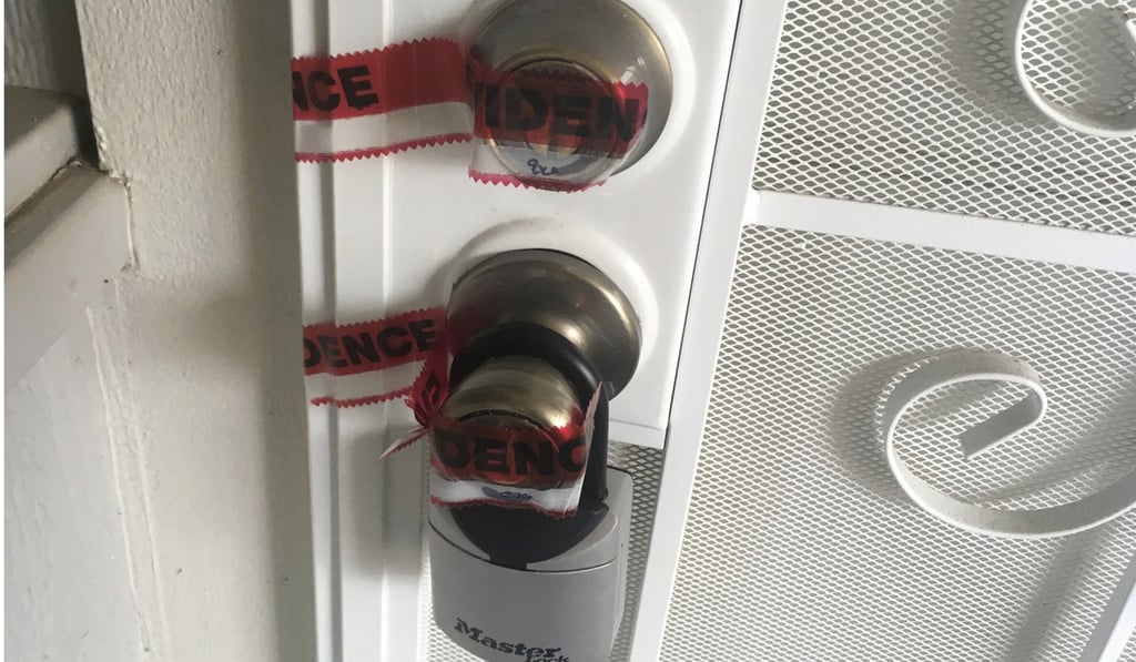 Red evidence tape covers part of the door leading to the condo where Ikaika Kang lives in Waipahu, Hawaii. Photo: AP