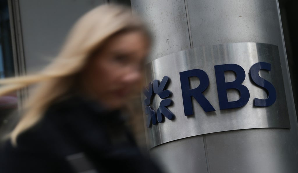 A woman walks past a Royal Bank of Scotland (RBS) sign in central London. Britain's bailed-out Royal Bank of Scotland agreed on Wednesday, July 12, 2017, to pay a US regulator US$5.5 billion (4.8 billion euros) over its role in the subprime mortgage crisis more than a decade ago. Photo: AFP A woman walks past a Royal Bank of Scotland (RBS) sign in central London. Britain's bailed-out Royal Bank of Scotland agreed on Wednesday, July 12, 2017, to pay a US regulator US$5.5 billion (4.8 billion euros) over its role in the subprime mortgage crisis more than a decade ago. Photo: AFP