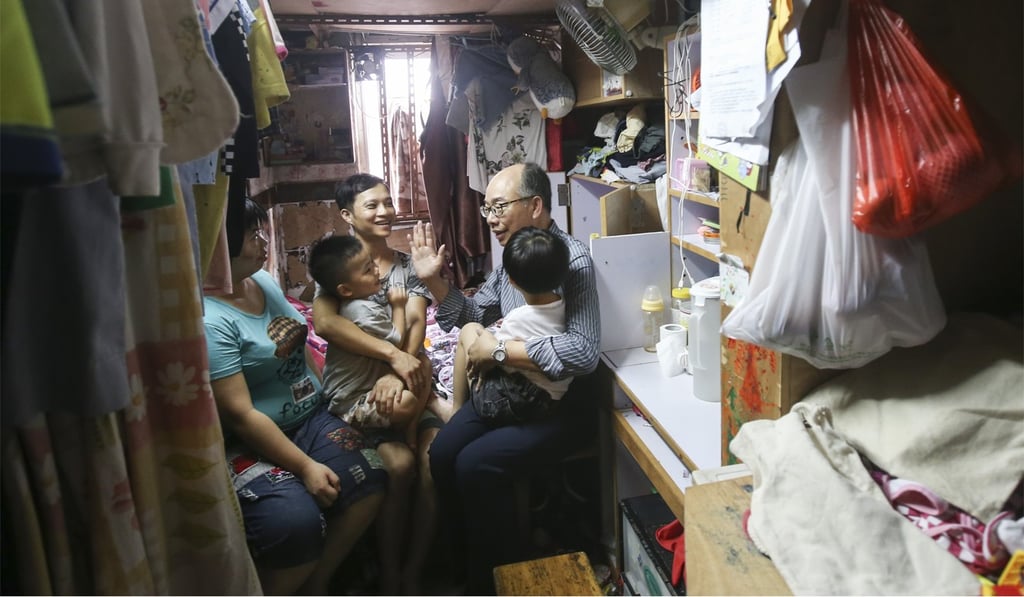 The Secretary for Transport and Housing, Frank Chan, at one of the grass-roots homes he visited in Sham Shui Po, on a trip organised by the Society for Community Organisation on July 9. David Wong