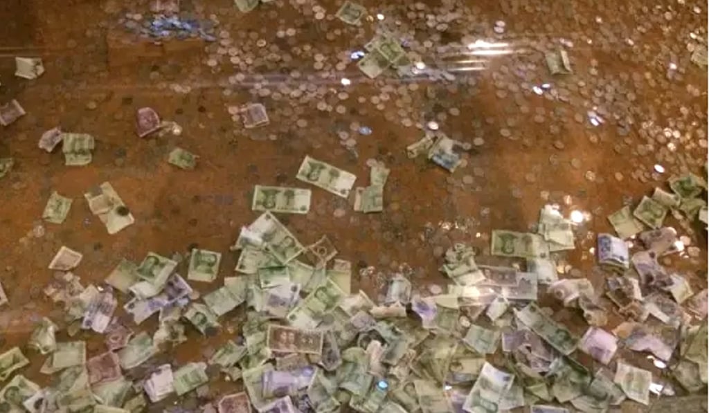 The operator of the pagoda ruins says the site is cleared of coins and notes every two weeks. Photo: Handout