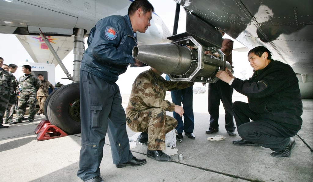 A PLA jet in Chengdu, Sichuan province, is checked before a cloud-seeding mission to induce rain, involving 14 planes, in March 2010. Photo: Xinhua