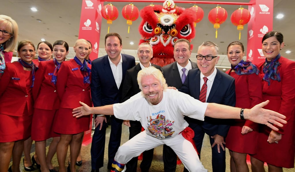 Virgin Group founder Richard Branson poses with local staff as he launches the inaugural Melbourne to Hong Kong flight for Virgin Australia on July 5. Photo: Reuters