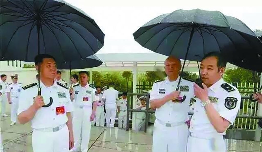 Admiral Wu Shengli (second right), then commander of the PLA Navy, holds an umbrella for Real Admiral Ma Weiming at the PLA Naval University of Engineering in Wuhan in June, 2016 . Photo: Handout Admiral Wu Shengli (second right), then commander of the PLA Navy, holds an umbrella for Real Admiral Ma Weiming at the PLA Naval University of Engineering in Wuhan in June, 2016 . Photo: Handout