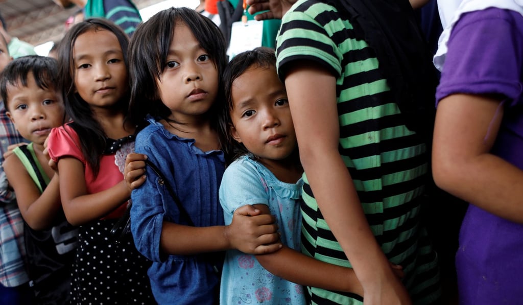 Children line up to receive lunch at an evacuation centre outside the city as army troops continue their assault against insurgents from the Maute group in Marawi, Philippines. Photo: Reuters