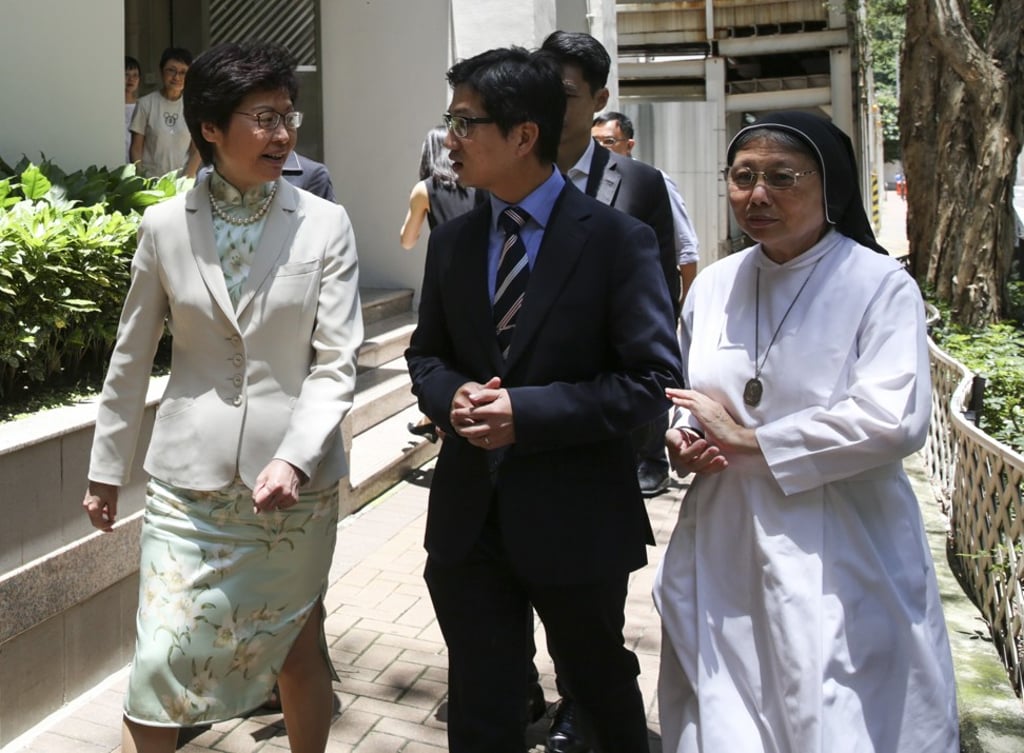 Carrie Lam meets the media after visiting her alma mater, St Francis’ Canossian College in Wan Chai, on July 11. She gave the students her best wishes for the DSE results the following day. Photo: Sam Tsang