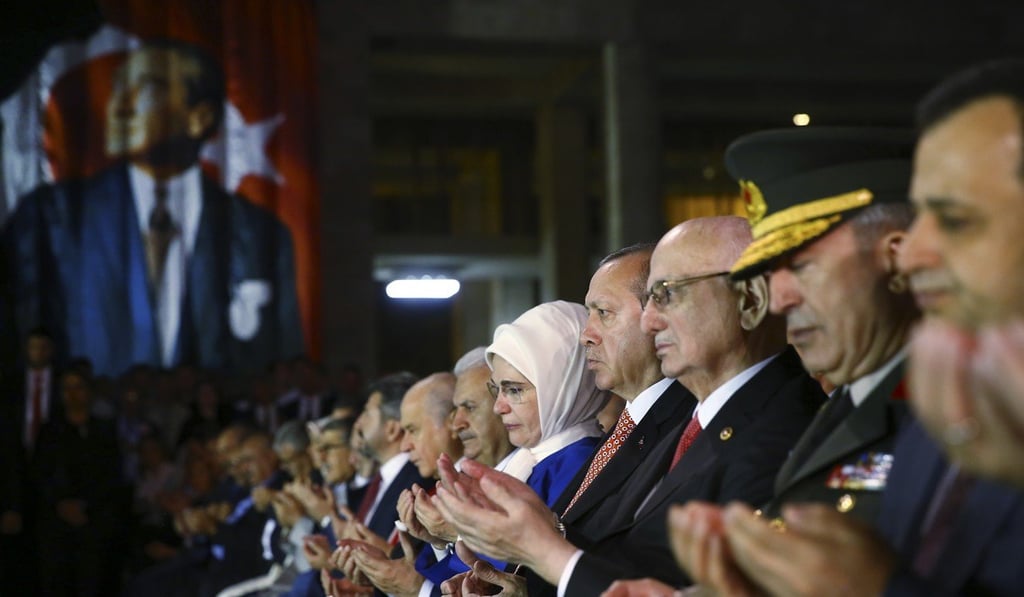 Erdogan (right of centre) prays during a ceremony at Turkey's parliament to commemorate the anniversary. Photo: AP Erdogan (right of centre) prays during a ceremony at Turkey's parliament to commemorate the anniversary. Photo: AP