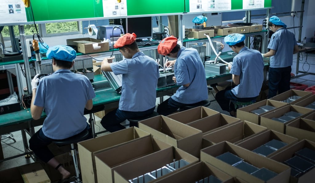 Shenzhen is China’s tech hub. Pictured, employees assemble computers used for bitcoin mining. Photo: EPA
