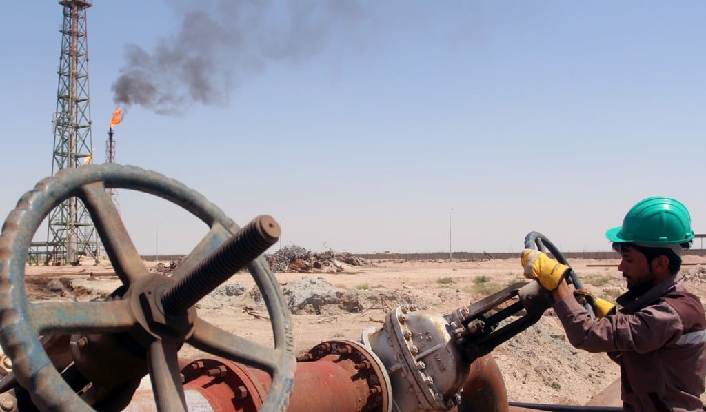 A worker checks the valve of an oil pipe at Al-Sheiba oil refinery in the southern Iraqi city of Basra. Photo: Reuters