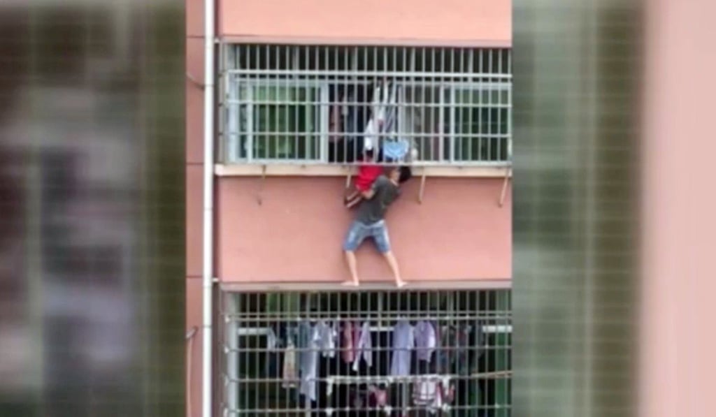 With little to hang on to, the neighbour lifted the boy through the window grille. Photo: Handout