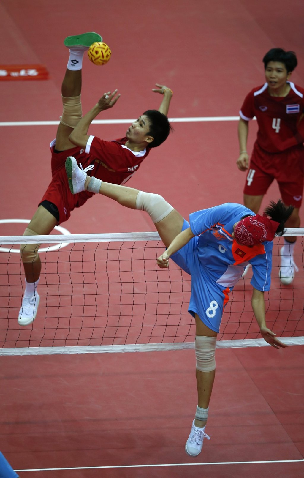 Thailand (red jersey) faces off with Vietnam during a women’s sepak takraw match at the 27th SEA Games in Naypyidaw, Myanmar, in December 2013. Photo: AP