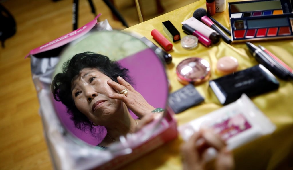 Park puts on make-up during her tutorial. Photo: Reuters