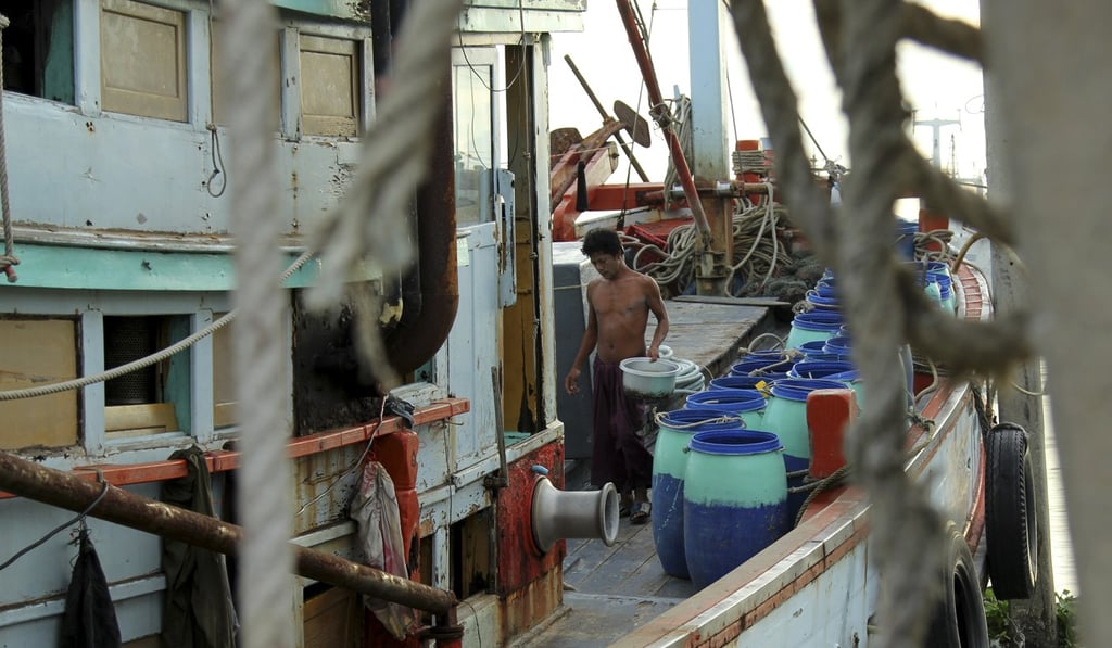 A Myanmese migrant cleans a fishing vessel in the port of Mahachai, one of the main hubs of the Thai fishing industry, a sector that has been linked to human-trafficking and slave-like conditions. Photo: Laura Villadiego
