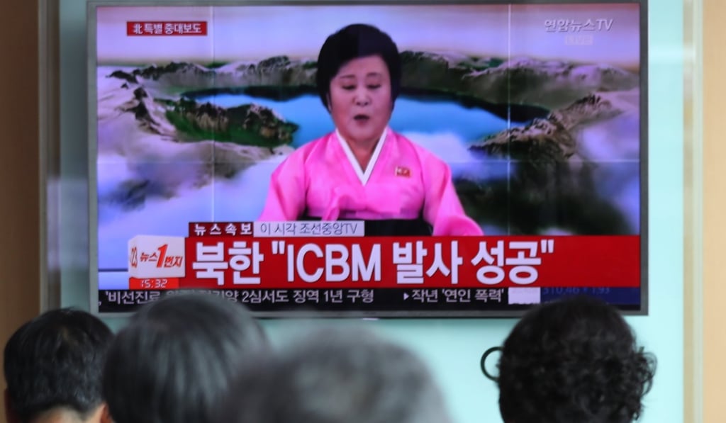 People watch a live TV report showing North Korea's special announcement that it has successfully tested an intercontinental ballistic missile, in Seoul. Photo: EPA