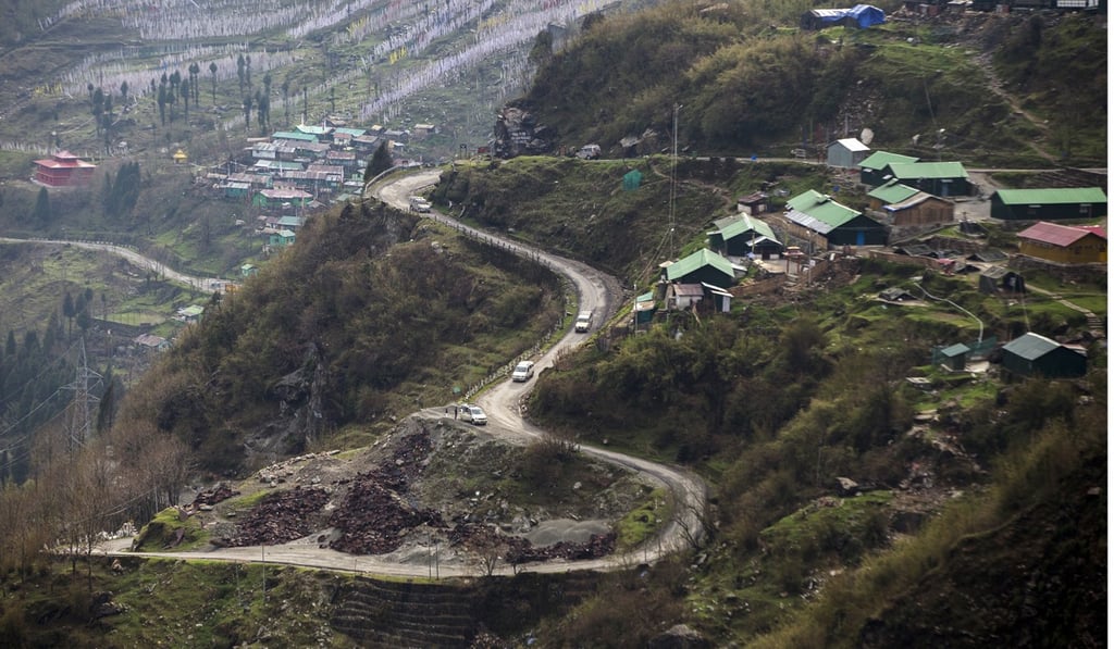Vehicles travel along a mountain road near the Nathula Pass, an open trading post in the Himalayas between India and China, in Sikkim, India. Photo; Bloomberg