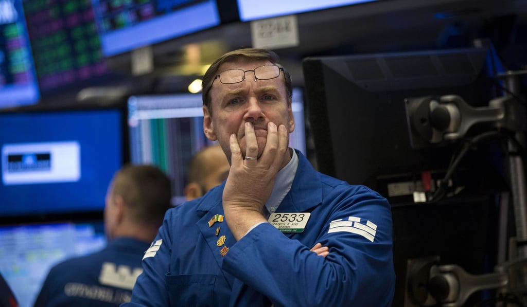 A trader pauses while working on the floor of the New York Stock Exchange ahead of the closing bell on July 18. Photo: AFP