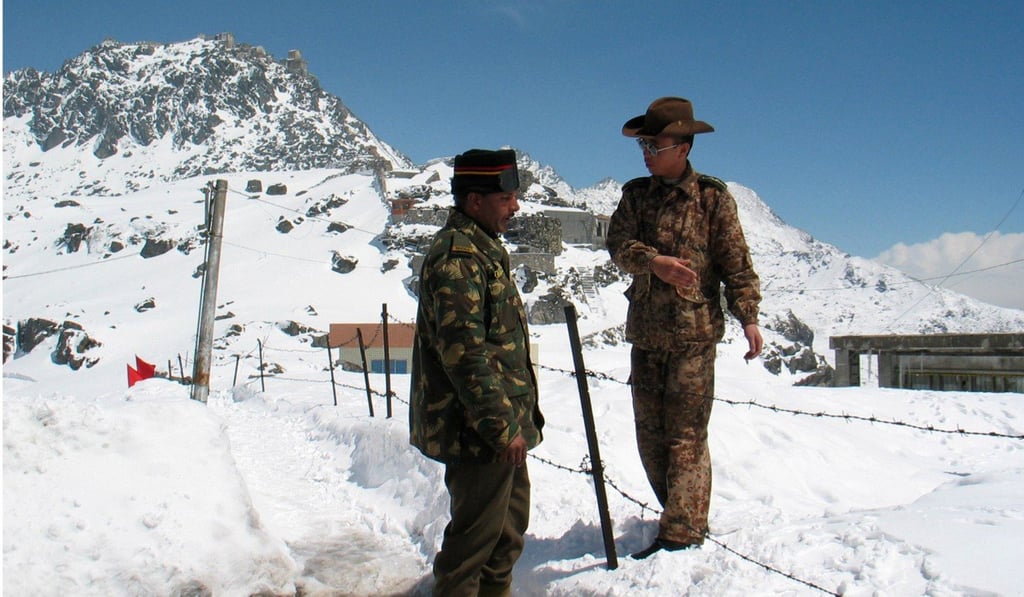 An Indian army officer talks with a Chinese soldier at the Nathu-la pass on the country's northeastern border with China. Photo: Reuters