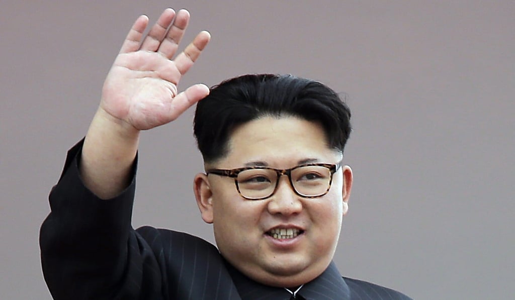 North Korean leader Kim Jong-un waves at parade participants in Pyongyang, North Korea. Photo: AP
