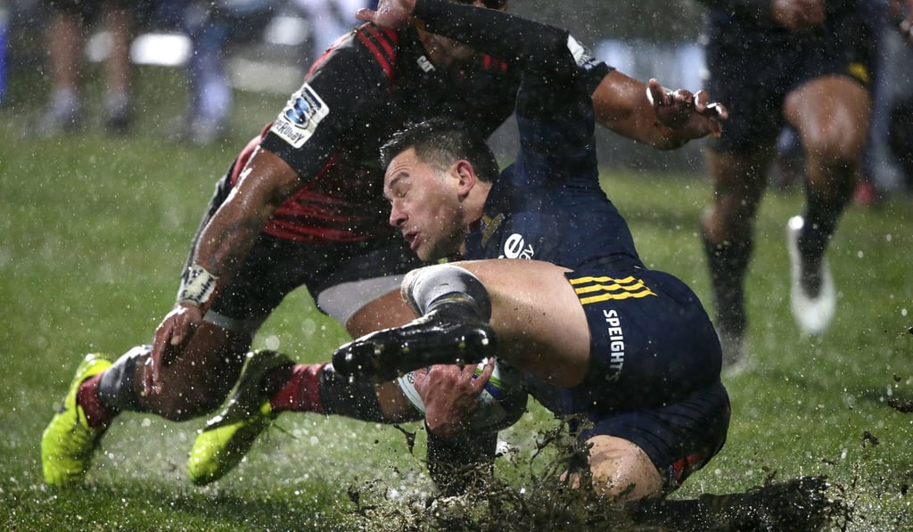 Ben Smith is tackled by Crusaders’ player Seta Tamanivalu during the Highlanders’ Super Rugby quarter-final loss. Photo: AP