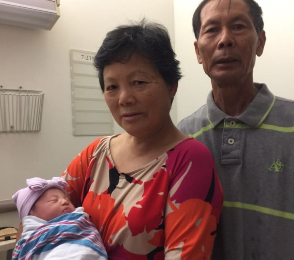 The parents of slain NYPD officer WenJian Liu cradle their granddaughter Angelina. Photo: NYPD The parents of slain NYPD officer WenJian Liu cradle their granddaughter Angelina. Photo: NYPD