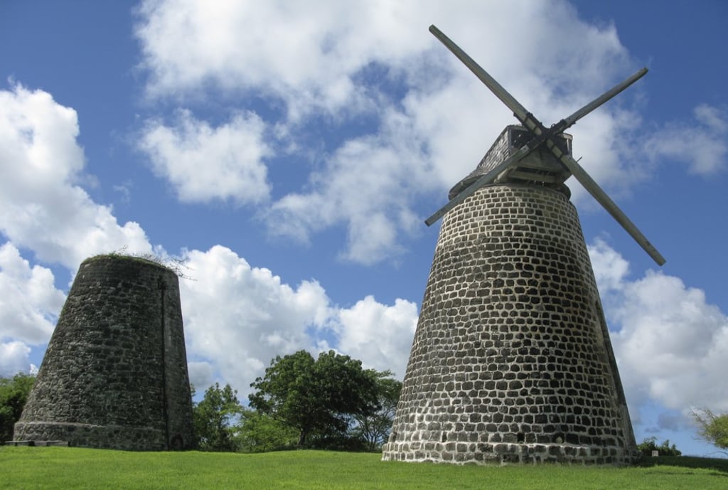 Sugar mills stand on a grassy hill on Betty's Hope, Antigua. The island made the list of destinations for Chinese high-net worth individuals looking to move abroad for the first time this year.